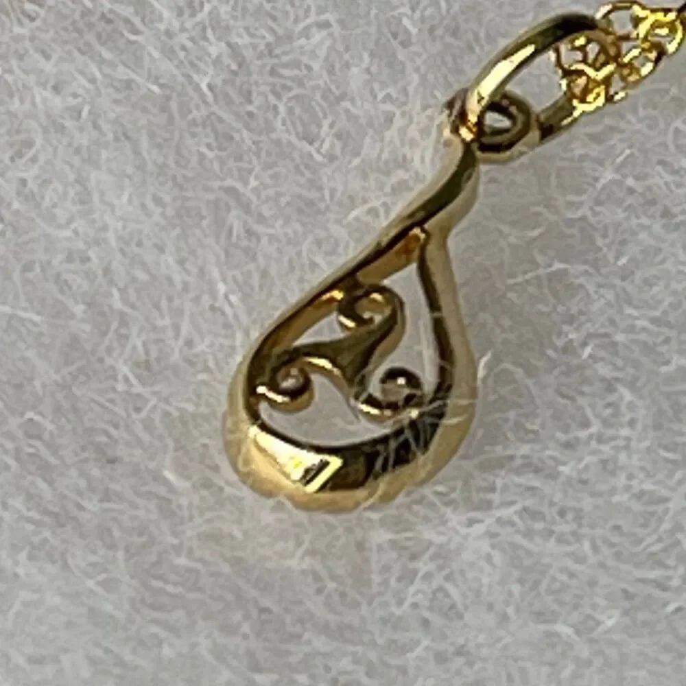 Sterling silver gold plated open work teardrop pendant and chain.